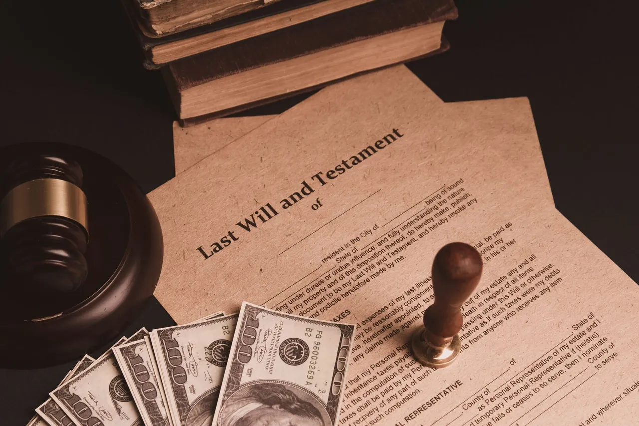 Last will and testament document with a gavel, a stamp and cash